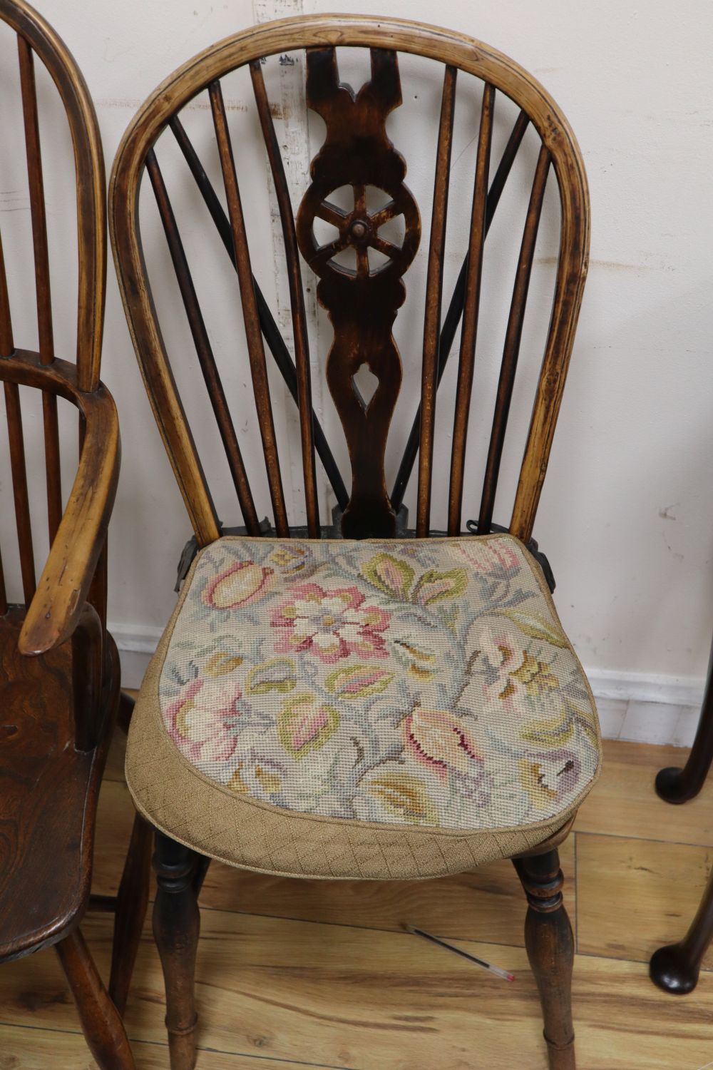 A 19th century ash, beech and elm Windsor wheelback armchair and a Windsor wheelback single chair